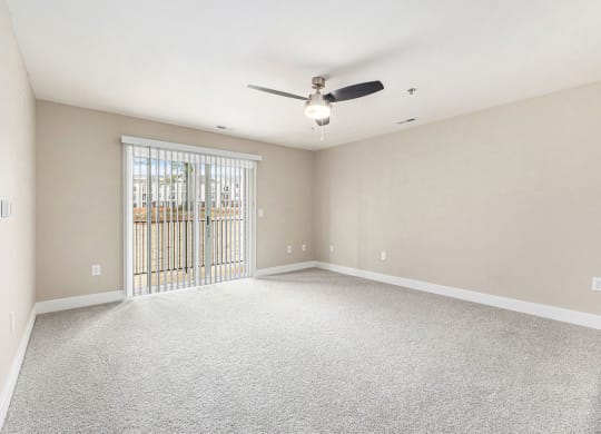 an empty living room with a ceiling fan and a window at Stoney Pointe Apartment Homes, Wichita, 67226