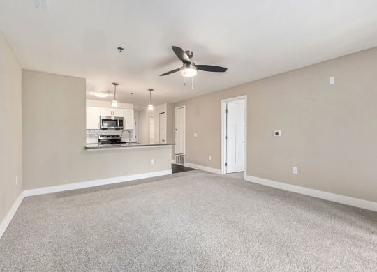 living room facing towards the kitchen with a ceiling fan at Stoney Pointe Apartment Homes, Kansas