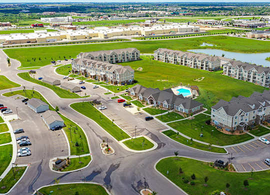 A drone view of an apartment community with a pool at Stoney Pointe Apartment Homes, Kansas, 67226