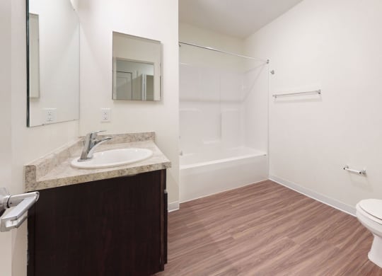 a bathroom with hard-surface flooring at Strathmore Apartment Homes, West Des Moines, 50266