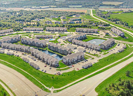 A large aerial view of an apartment community with multiple buildings at Strathmore Apartment Homes, Iowa