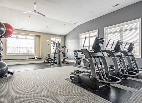 Cardio machines in fitness center at Strathmore Apartment Homes, Iowa