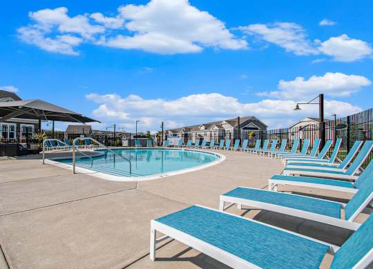 Swimming pool with lounge chairs at Strathmore Apartment Homes in West Des Moines, Iowa