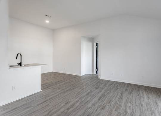 A room with a wooden floor and a sink. at Sundance Apartments, Indianapolis, Indiana