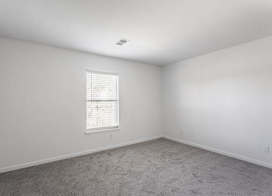 A room with a window and carpeted floor. at Sundance Apartments, Indianapolis, IN