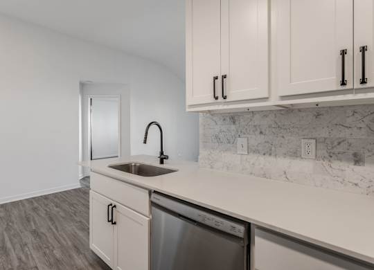 A kitchen with a white sink and cabinets. at Sundance Apartments, Indianapolis, 46237
