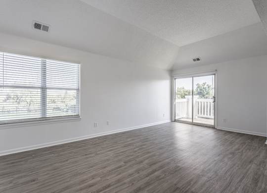 A room with wooden flooring and a window with blinds. at Sundance Apartments, Indianapolis