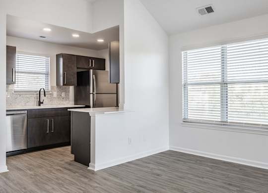 A kitchen with a stainless steel refrigerator, dishwasher, and oven. at Sundance Apartments, Indianapolis, Indiana