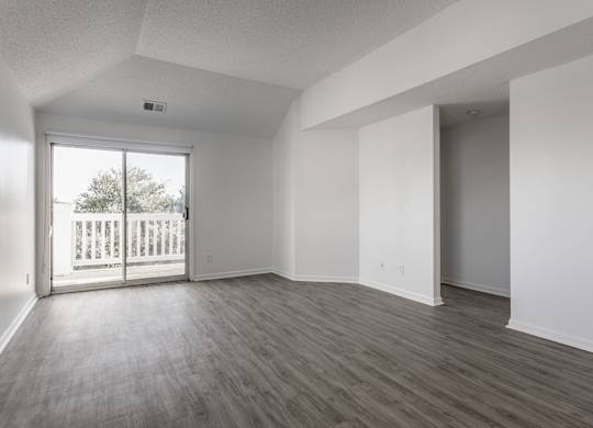 A room with a sliding glass door leading to a balcony. at Sundance Apartments, Indianapolis, IN