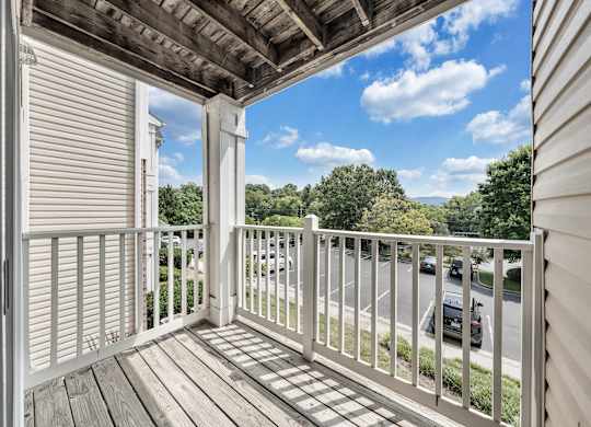 A balcony with a white railing and a view of the street below. at Sunscape Apartments, Roanoke, 24018