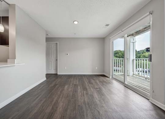A room with a sliding glass door leading to a balcony. at Sunscape Apartments, Virginia, 24018