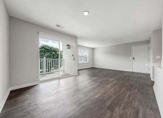 A room with a sliding glass door leading to a balcony. at Sunscape Apartments, Virginia, 24018