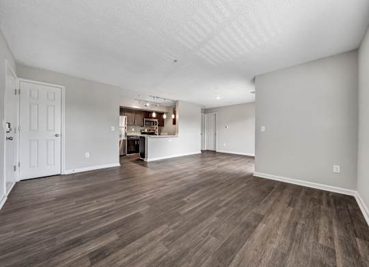 A room with wooden flooring and white walls. at Sunscape Apartments, Virginia, 24018