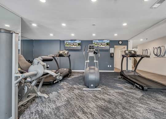 A gym with a treadmill, exercise bike, and weight machine. at Sunscape Apartments, Virginia, 24018