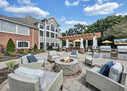 A patio with a fire pit and seating area. at Sunscape Apartments, Virginia, 24018