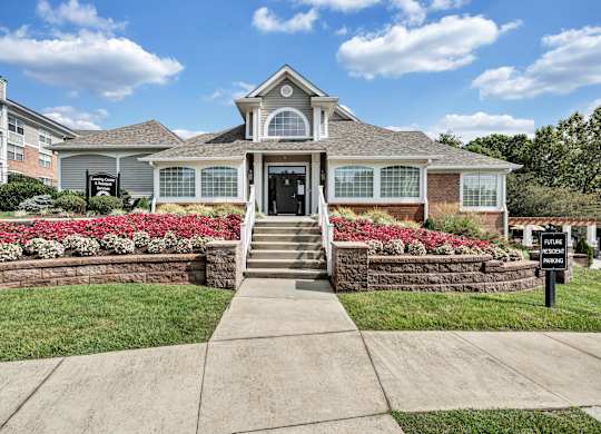 A house with a front yard and a sign that says  at Sunscape Apartments, Virginia, 24018