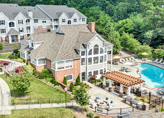 A large building with a pool in front of it. at Sunscape Apartments, Virginia