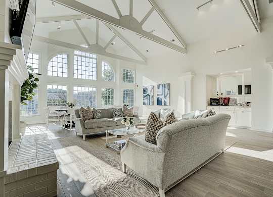 A living room with a couch and a television. at Sunscape Apartments, Virginia