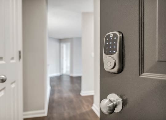 A modern door with a keypad lock. at Sunscape Apartments, Roanoke, Virginia