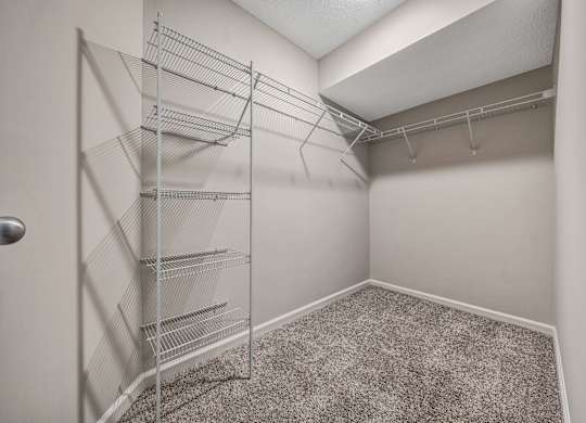 A room with a carpeted floor and a door with a handle. at Sunscape Apartments, Virginia