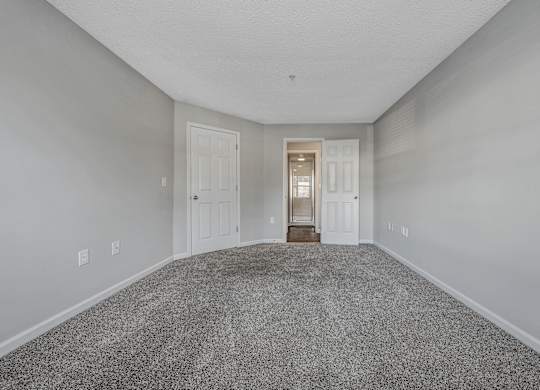 A room with a carpeted floor and two doors. at Sunscape Apartments, Virginia, 24018