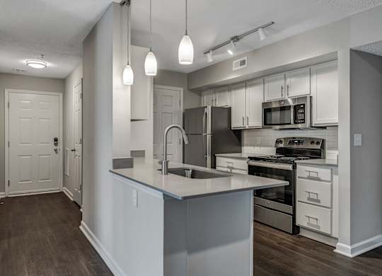 A modern kitchen with a large island and stainless steel appliances. at Sunscape Apartments, Virginia, 24018