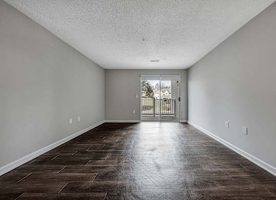A room with a brown floor and white walls. at Sunscape Apartments, Roanoke, VA, 24018