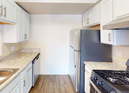 a kitchen with white cabinets and stainless steel appliancesat Swiss Valley Apartments, Wyoming, MI, 49509