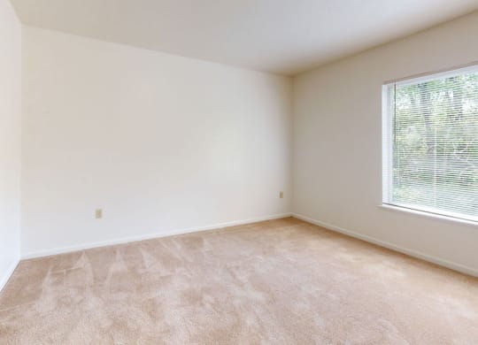 an empty bedroom with a closet and a window at Tall Oaks Apartment Homes, Kalamazoo, 49009