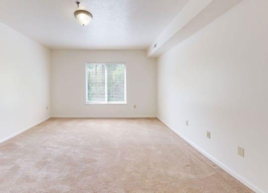 an empty bedroom with a window at Tall Oaks Apartment Homes, Kalamazoo, 49009