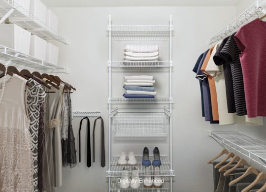 a walk in closet with wardrobe organizers at Tall Oaks Apartment Homes, Michigan
