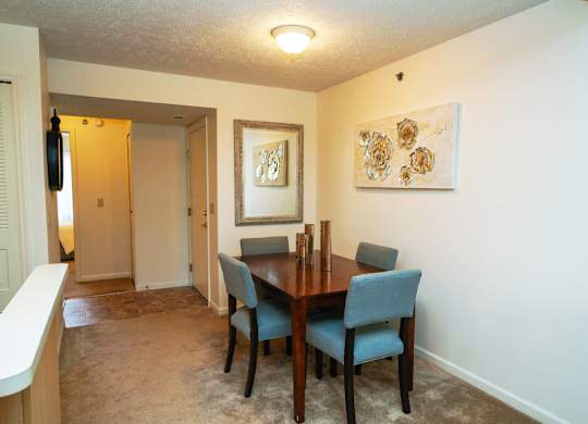 A dining room with a table and chairs at Tall Oaks Apartment Homes, Michigan
