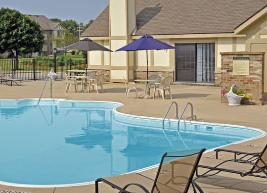Poolside Lounge Chairs and Umbrellas at Tanglewood Apartments in Oak Creek, WI