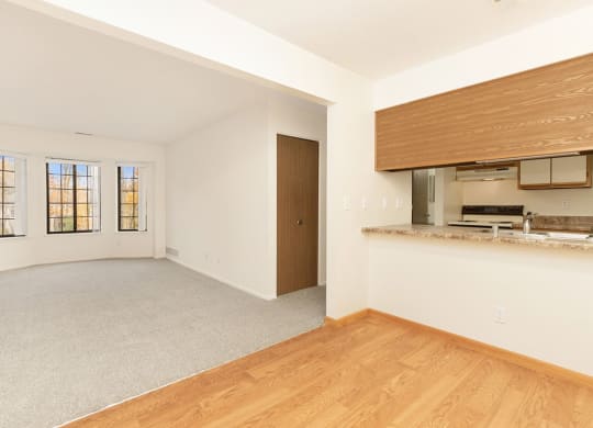 an empty living room and kitchen with a wood floor at Tanglewood Apartments, Oak Creek, WI, 53154