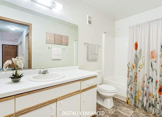 A bathroom with a sink, toilet, and shower at Tanglewood Apartments, Oak Creek