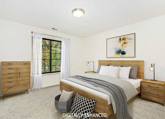 A spacious bedroom with a large bed and a window at Tanglewood Apartments, Oak Creek
