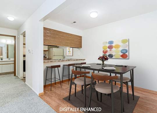 A kitchen and a dining table set for two at Tanglewood Apartments, Oak Creek