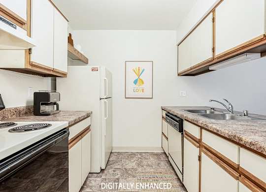 A galley style kitchen with a dishwasher at Tanglewood Apartments, Oak Creek