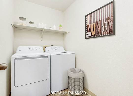 A laundry room with a washer and dryer and a shelf at Tanglewood Apartments, Oak Creek
