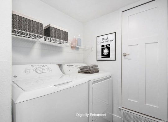 a laundry room with a washer and dryer at The Crossings Apartments, Michigan, 49508