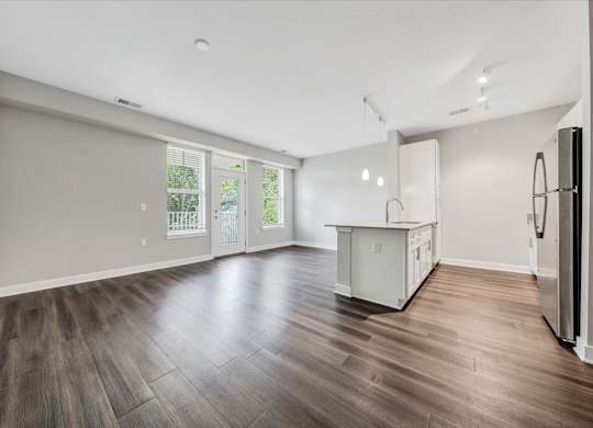 A kitchen area with a refrigerator on the right side at The Retreat Apartments, Roanoke, 24019