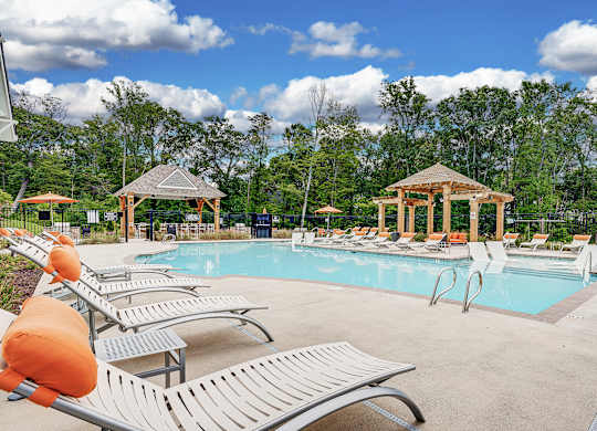 A pool with sun loungers and a gazebo at The Retreat Apartments, Roanoke, 24019