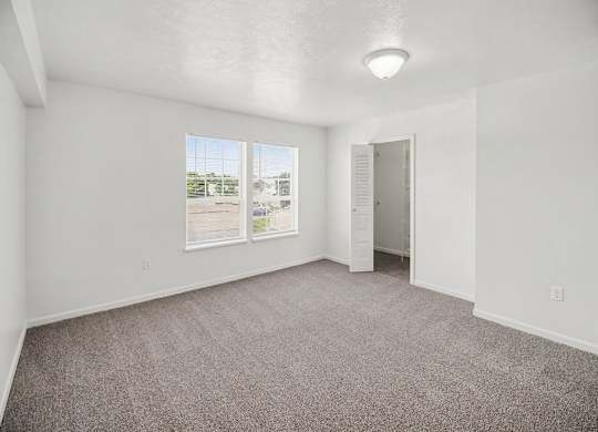 A spacious bedroom with a walk-in closet and a window at Tracy Creek Apartments, Ohio