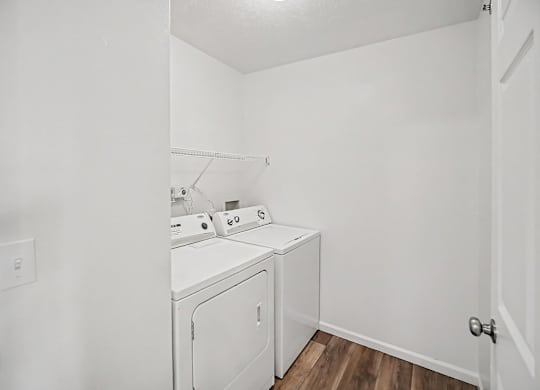 A laundry room with a washer and dryer at Tracy Creek Apartments, Ohio