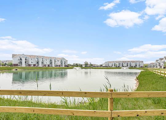 A row of apartment buildings are built on a pond at Tracy Creek Apartments, Perrysburg