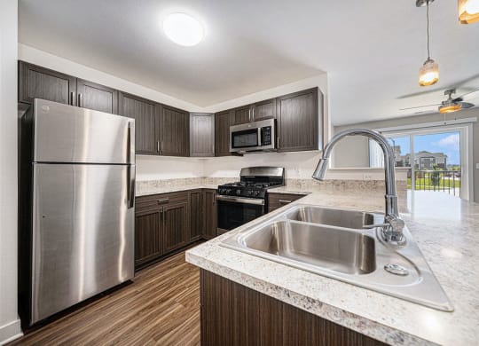 a kitchen with stainless steel appliances at Trade Winds Apartment Homes, Elkhorn, Nebraska