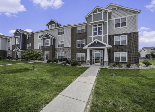 well maintained apartment building with grass at Trade Winds Apartment Homes in Elkhorn, NE 68022