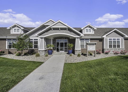 a large house with a sidewalk in front of it at Trade Winds Apartment Homes in Elkhorn, NE 68022