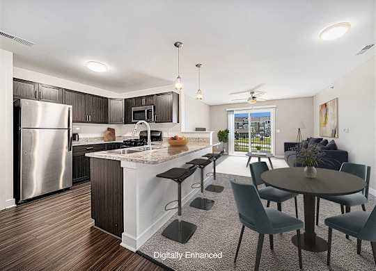 an open kitchen and living room with a stainless steel appliances at Trade Winds Apartment Homes, Elkhorn, Nebraska
