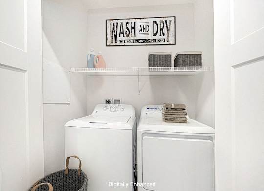 A laundry room with a full size washer and dryer at Trade Winds Apartment Homes, Elkhorn, Nebraska